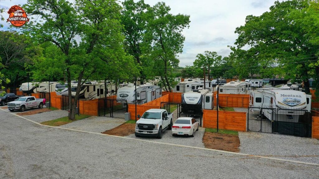 Aerial view of gated RV sites with wood privacy fences at Dallas Shady Oaks RV Park
